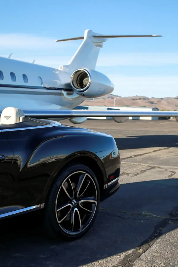 Black car beside a jet